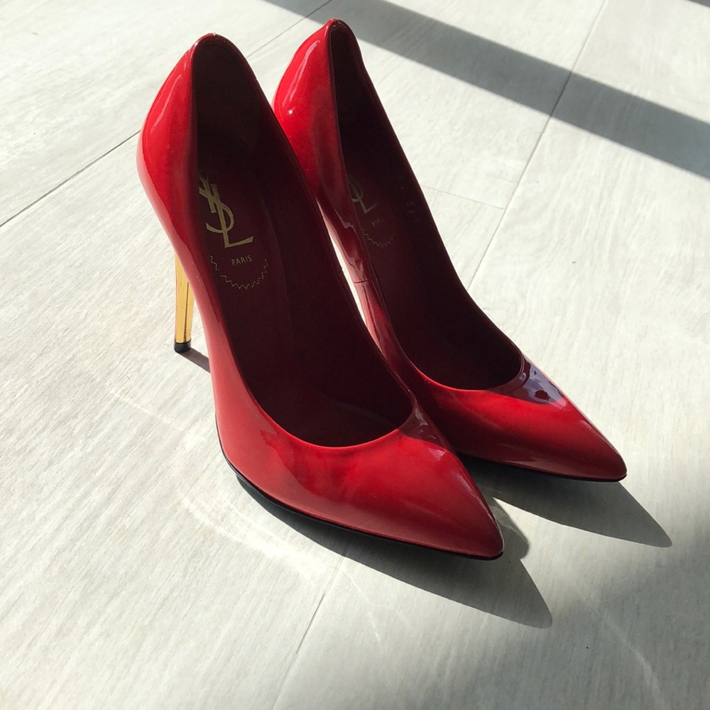 Red YSL pumps with gold accents
